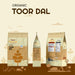 Rajamudi Organic Toor Dal packaging on a beige background with minimalistic illustrations.